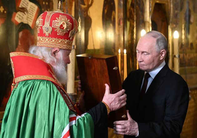 Russian President Vladimir Putin (R) and Russia's Orthodox Patriarch Kirill attend a service in the Annunciation Cathedral following Putin's inauguration ceremony at the Kremlin in Moscow on May 7, 2024.