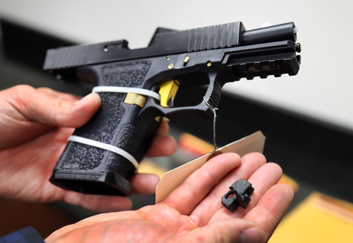 A machine gun conversion device for a Glock hand gun in custody of the ATF Boston Bureau. The device can convert the Glock into a machine gun after the "switch" is installed.