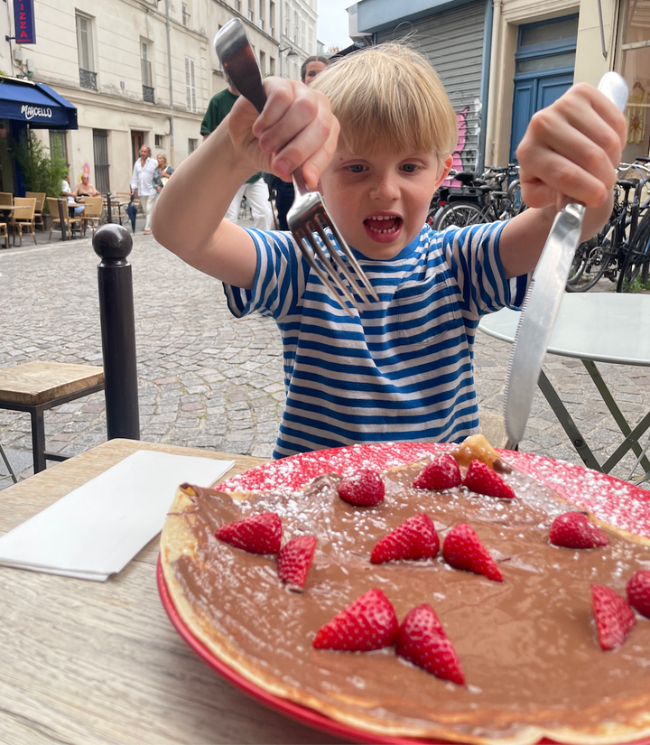 The author's son eating a crepe.