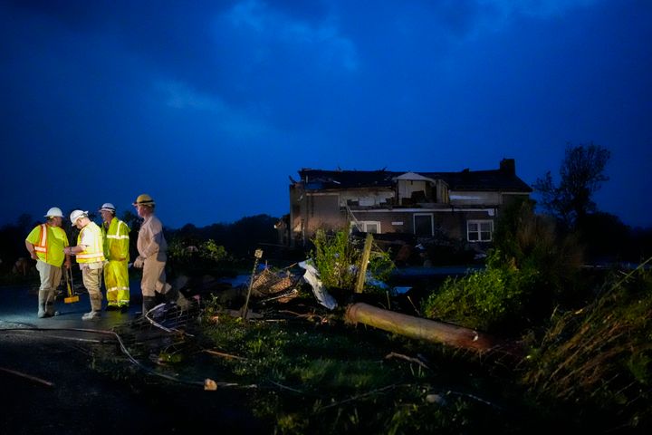 Utility workers survey storm damage along Cothran Road on May 8, 2024, in Columbia, Tenn. 