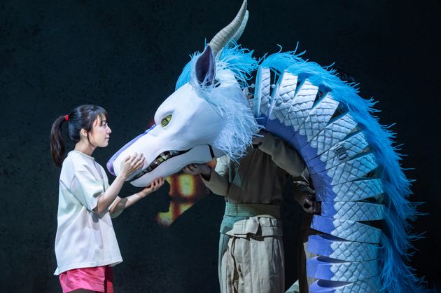 The play features complex puppetry like this moment with Haku in his dragon form