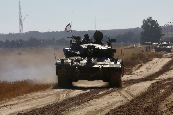 Israeli tanks are seen near the Shalom Kerem crossing in southern Israel bordering the Gaza Strip, on May 6, 2024.