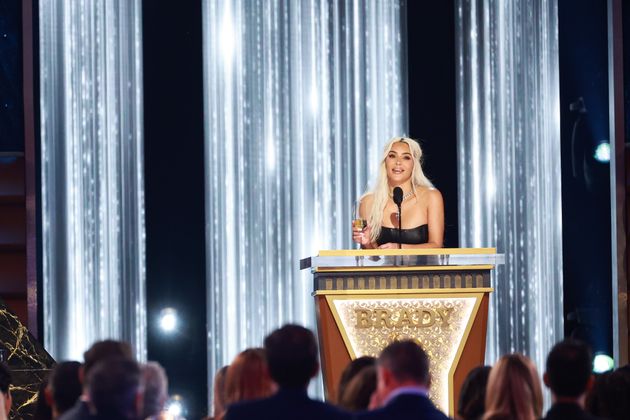 Kim Kardashian speaks on stage during Netflix's roast of Tom Brady