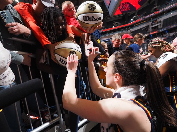 INDIANAPOLIS, IN - MAY 9: Caitlin Clark #22 of the Indiana Fever autographs after the game against the Atlanta Dream on May 9, 2024 at Gainbridge Fieldhouse in Indianapolis, Indiana. NOTE TO USER: User expressly acknowledges and agrees that, by downloading and or using this Photograph, user is consenting to the terms and conditions of the Getty Images License Agreement. Mandatory Copyright Notice: Copyright 2024 NBAE (Photo by Ron Hoskins/NBAE via Getty Images)