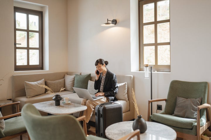 Business traveler waiting in the lobby of a luxury hotel