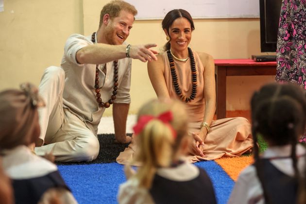 Prince Harry and Meghan Markle meet with children during a visit to the Lightway Academy in Abuja on Friday, May 10, as they visit Nigeria.