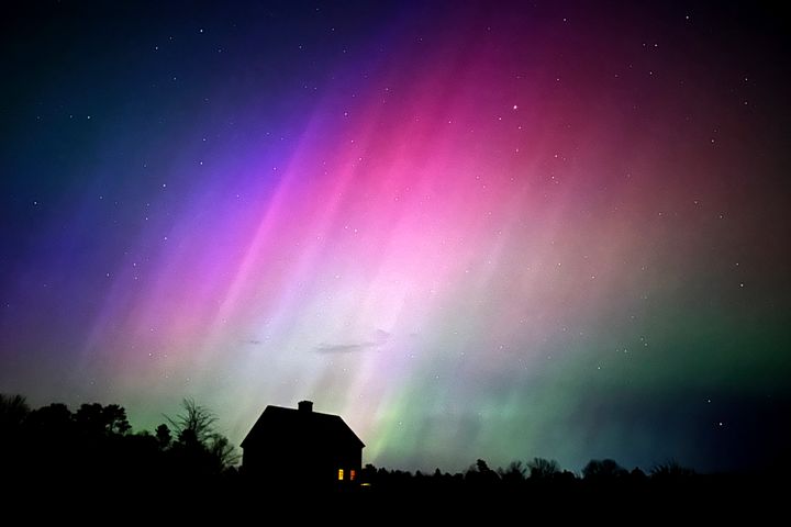 The Northern Lights blaze over a farmhouse in Brunswick, Maine, late Friday, May 10, 2024. 