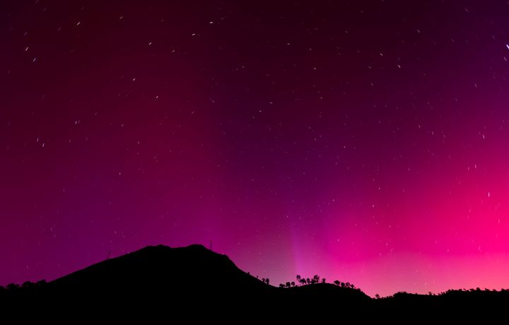 The aurora borealis is visible over Lake Berryessa, California, near midnight on Saturday, November 11, 2024. 