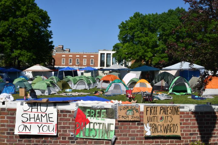 Banners and signs along a fence at the protest encampment at Johns Hopkins University in Baltimore, Maryland, on May 2, 2024. Students are joining in protests sweeping college campuses over the Israel/Gaza conflict.