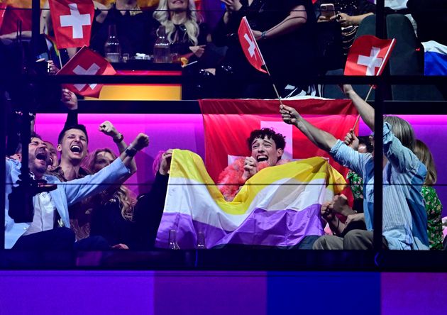 The Swiss delegation holding up the non-binary flag, after previously being told this would not be allowed inside the arena