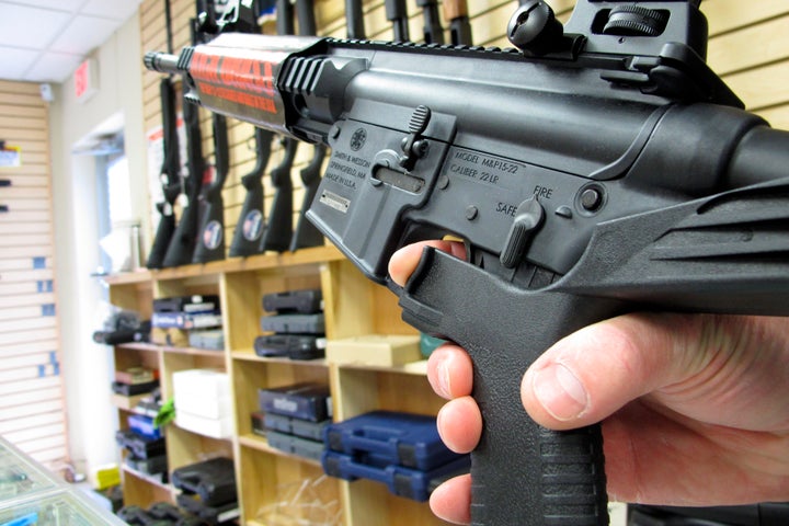 An employee of North Raleigh Guns in Raleigh, North Carolina, demonstrates how a bump stock works in 2013.