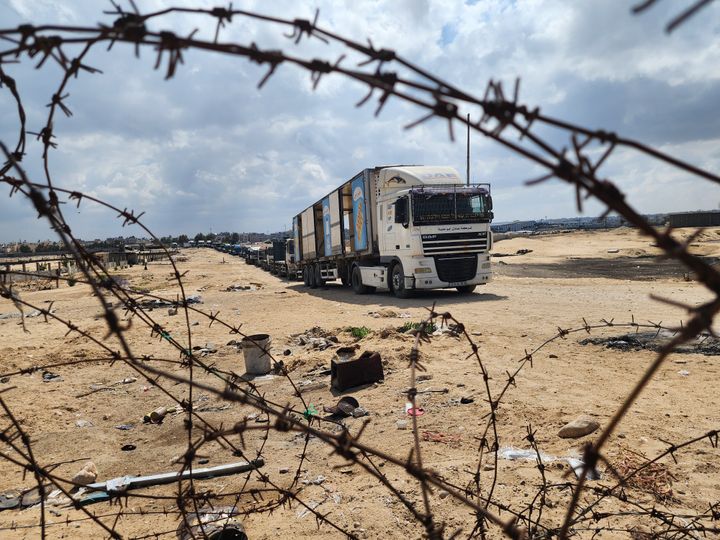 Palestinian truck drivers and United Nations vehicles wait near the Rafah border gate on the Gazan side to cross the Egyptian side after the Israeli army took control of the vital crossing and announced that it would close the entrance of aid supplies, as Israeli operations continue in Rafah, Gaza on May 14, 2024.