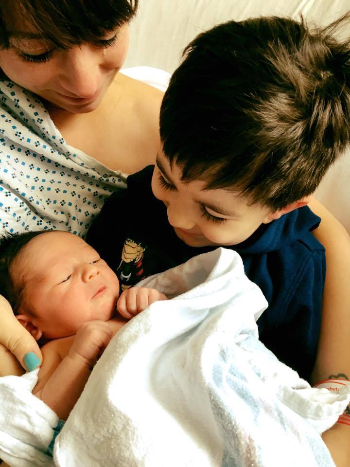 The author's oldest son meeting her youngest son in the hospital for the first time