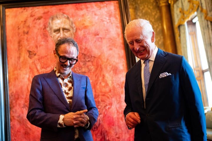 Yeo and Charles stand in front of the portrait of the monarch as it is unveiled May 14.