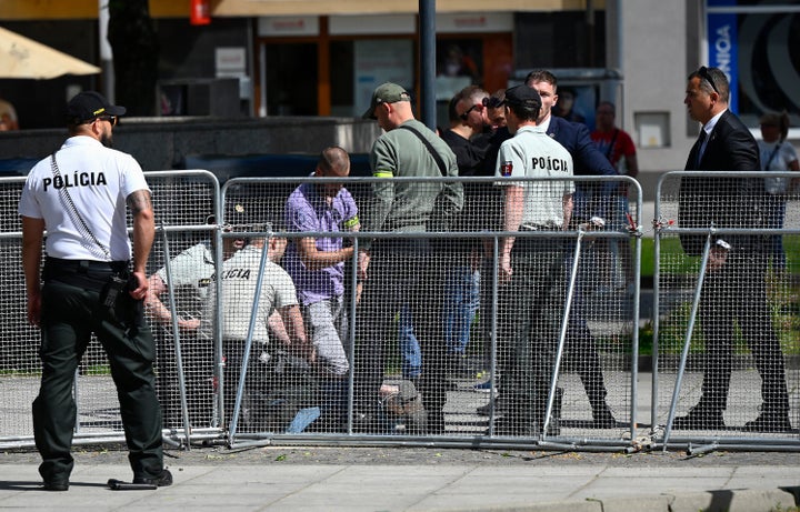 This photo shows security personnel apprehending a suspected gunman after Slovakia's Prime Minister was shot in Handlova, Slovakia on May 15, 2024. (Photo by AFP via Getty Images)