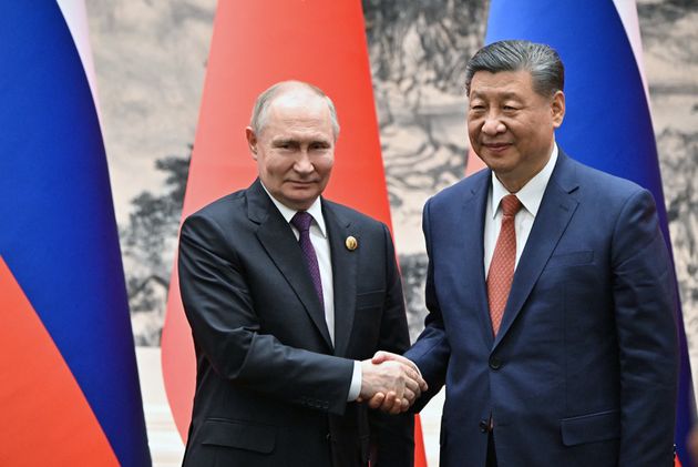 Russia's President Vladimir Putin (L) and China's President Xi Jinping shake hands during their meeting in Beijing on May 16, 2024.