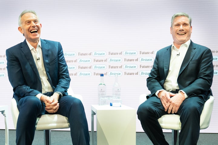 Former Prime Minister Tony Blair (left) and Labour leader Sir Keir Starmer discuss politics during the Tony Blair Institute