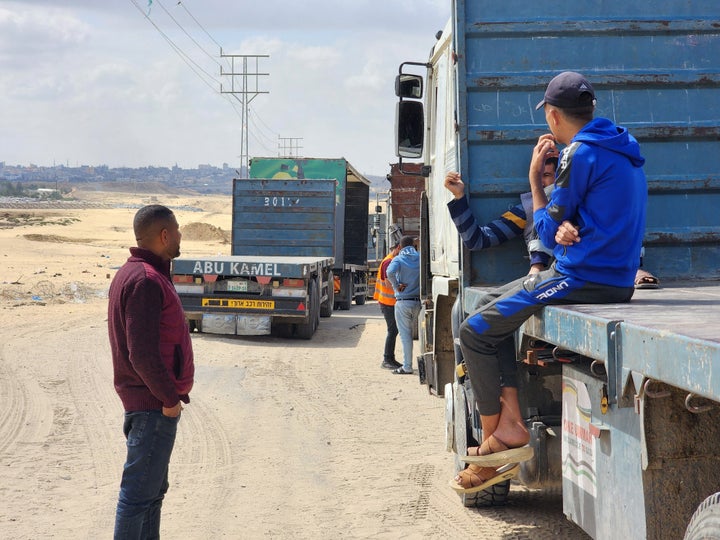 Palestinian truck drivers and United Nations vehicles wait Tuesday near the Rafah crossing on the Gaza side to cross into Egypt.