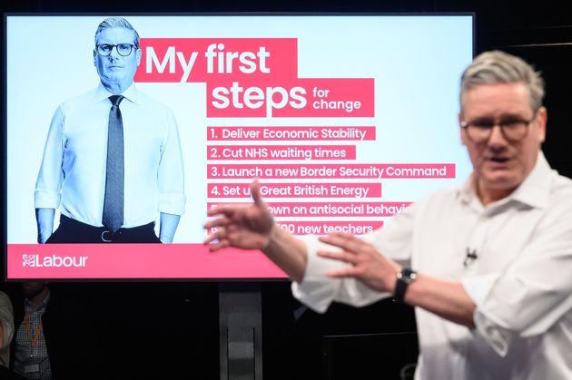 Keir Starmer stands in front of a screen displaying his six election pledges during the launch event in Essex.