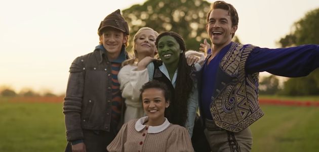 Wicked cast members Ethan Slater, Ariana Grande, Cynthia Erivo, Jonathan Bailey and Marissa Bode pose for a behind-the-scenes photo