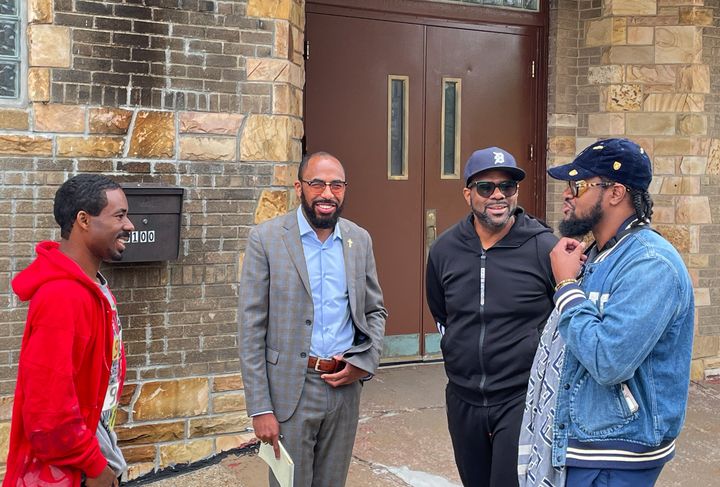 Carlos Topp, Quincy Coleman and Harlan "Jay" Bivens stand outside the King Solomon Baptist Church on Detroit's west side. Rev. Charles Williams II (in the black exercise suit) brought the group together to talk about the election.