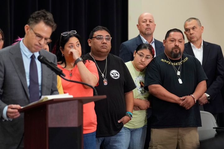 Families of the victims of an elementary school shooting listen to attorney Josh Koskoff at a Wednesday news conference in Uvalde, Texas. The families of 19 of the victims announced a lawsuit against nearly 100 state police officers who were part of the botched law enforcement response. The families also said they agreed to a $2 million settlement with the city.