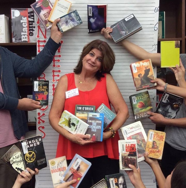 The author participates in a photo event during "Banned Books Week," holding some banned and challenged library books.