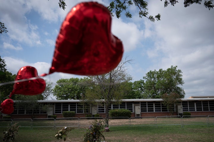 A heart-shaped balloon flies decorating a memorial site outside Robb Elementary School in Uvalde, Texas, Monday, May 30, 2022. (AP Photo/Wong Maye-E, File)