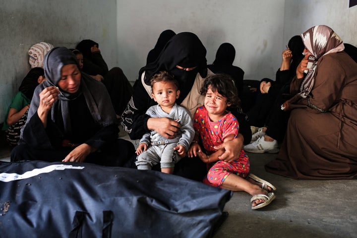 Women and children mourn loved ones killed in an Israeli attack, at a health clinic in the southern Gaza area of Tel al-Sultan in Rafah on May 26, 2024.