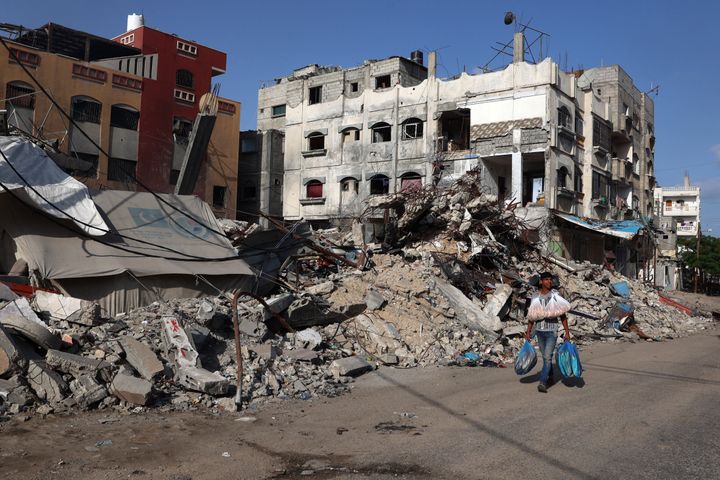 A Palestinian man walks past a destroyed building in Rafah in the southern Gaza Strip on May 26, 2024. Palestinian medics said that 22 people were killed in an Israeli airstrike in the city on Sunday.