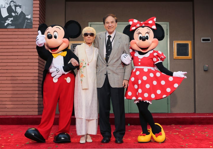 Mickey Mouse, from left, Elizabeth Gluck, Richard M. Sherman and Minnie Mouse pose for a photo at the ceremony honoring the Sherman Brothers with the rename of Disney Studios Soundstage A at the world premiere of Disney's "Christopher Robin" at the Walt Disney Studios in 2018.