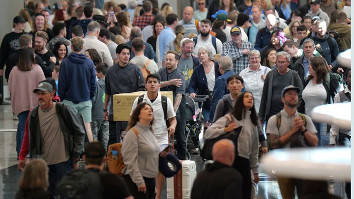 Travelers walk through Salt Lake City International Airport on May 24.
