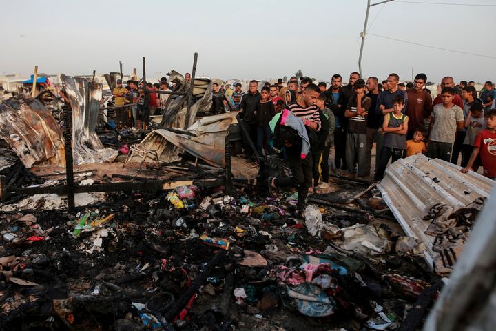 Παλαιστίνιοι κοιτάζουν την καταστροφή μετά από ισραηλινό χτύπημα όπου έμεναν εκτοπισμένοι στη Ράφα, στη Λωρίδα της Γάζας, Δευτέρα 27 Μαΐου 2024.