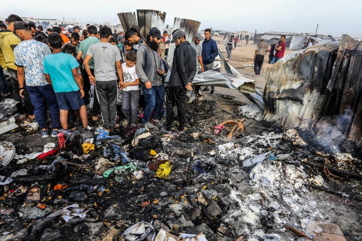 Palestinians inspect their destroyed tents after an Israeli air strike in Rafah.