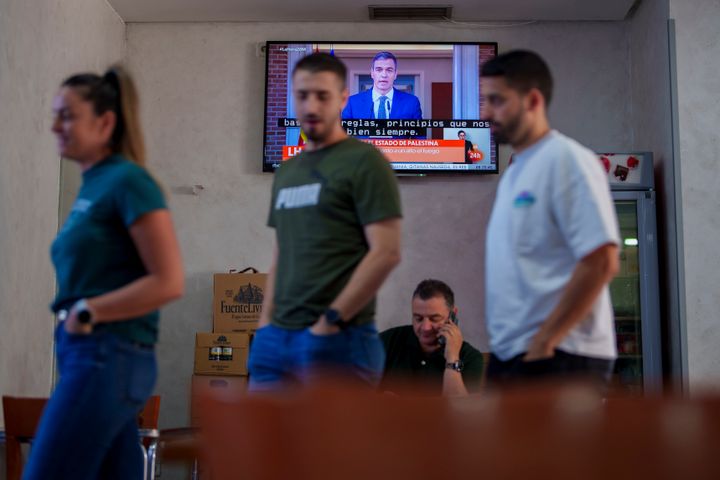 Πελάτες στέκονται μέσα σε ένα εστιατόριο ενώ ο Ισπανός πρωθυπουργός Pedro Sanchez εμφανίζεται σε τηλεοπτική μετάδοση στο Rivas Vaciamadrid, Ισπανία, Τρίτη, 28 Μαΐου 2024. Ο πρωθυπουργός Pedro Sanchez λέει ότι το ισπανικό υπουργικό συμβούλιο θα αναγνωρίσει το παλαιστινιακό κράτος σε συνεδρίασή του, καθώς ιευρύνεται το ρήγμα ανάμεσα σε χώρες της Ευρωπαϊκής Ένωσης με το Ισραήλ. (AP Photo/Manu Fernandez)