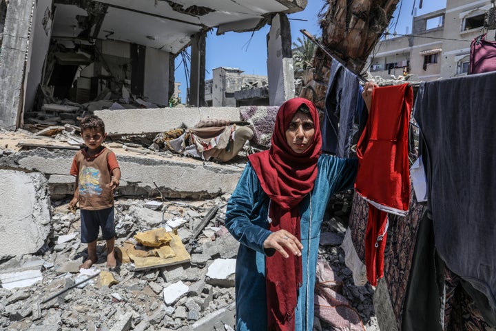 Palestinians seeking refuge in Deir al-Balah, after the Israeli army attacked a designated "safe zone" in Rafah, struggle to survive among the rubble of destroyed buildings on May 30, 2024.