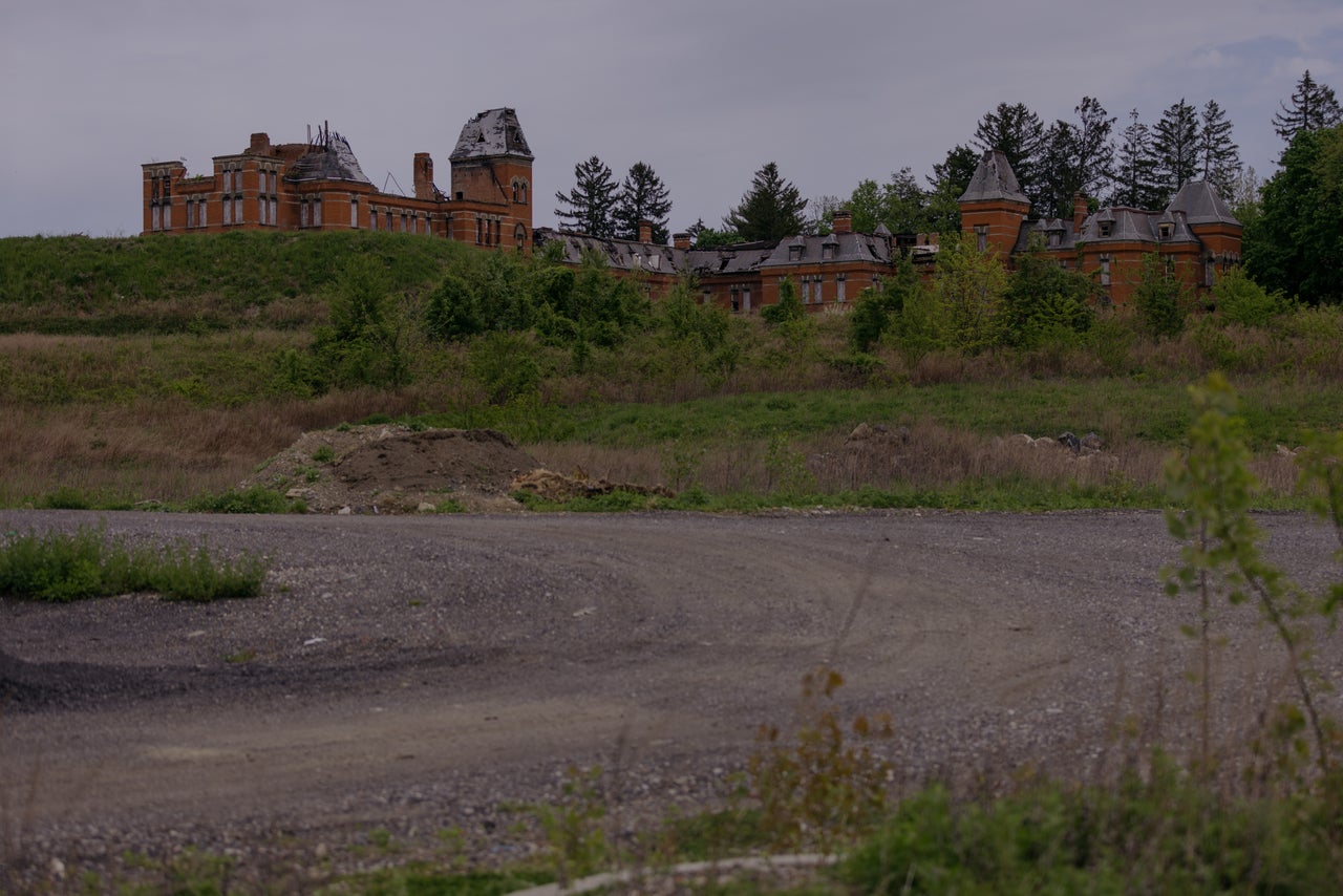 Hudson River State Hospital's last patients left in 2003 as part of America's "deinstitutionalization." Today the burnt-out remains of the property overlook a retail development.