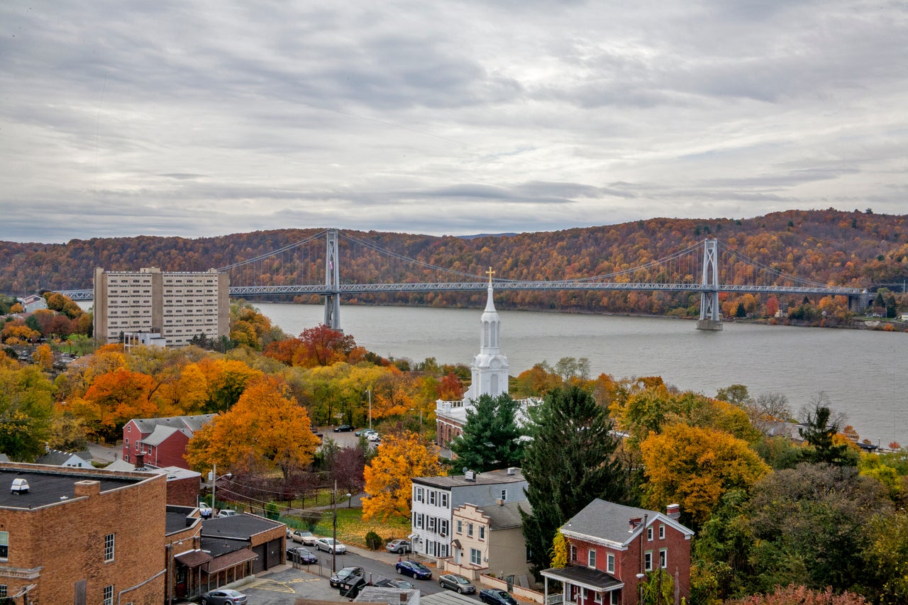 A view of the town of Poughkeepsie, New York, in autumn with the Mid-Hudson Bridge across the Hudson River.