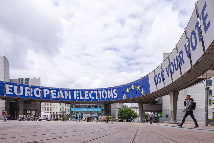 People walk outside the European Parliament prior to a debate with the lead candidates for the European Parliament elections in Brussels, Thursday, May 23, 2024. European elections will take place from June 6-9, 2024. (AP Photo/Geert Vanden Wijngaert)