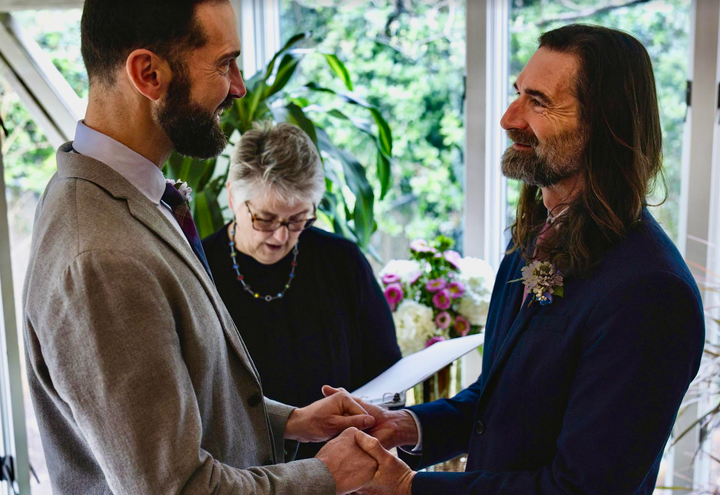 The author (left) and Tony getting married in their home in Virginia.