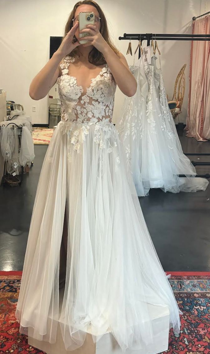 The author trying on a wedding dress (but not THE dress) in November 2023.