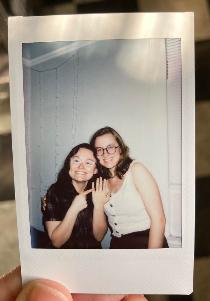A Polaroid of the author (right) and Rachael. "This was taken at a little gathering we had a few days afterward we got engaged in February 2023," she writes.