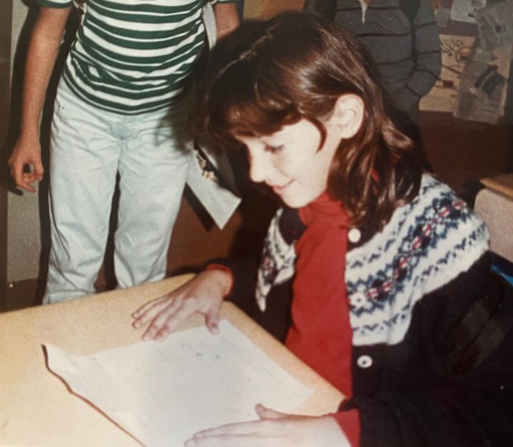 The author is pictured as an elementary school student.