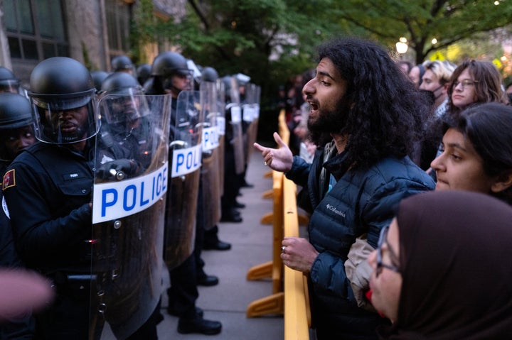 University police are confronted by protestors as they block access to the Main Quadrangle on the University of Chicago campus while they break up a pro-Palestinian encampment on May 7 in Chicago, Illinois.