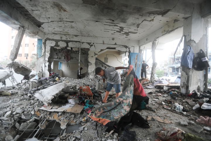 Palestinians look at the aftermath of the Israeli strike on a U.N.-run school that killed dozens of people in Gaza's Nuseirat refugee camp, on Thursday, June 6, 2024.