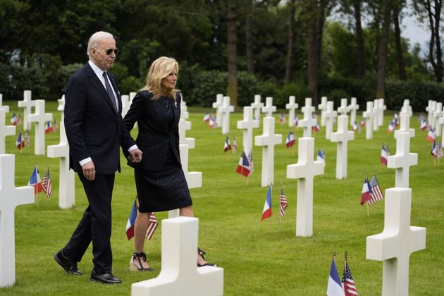 President Joe Biden and first lady Jill Biden walk in the Normandy American Cemetery following a ceremony to mark the 80th anniversary of D-Day, Thursday, June 6, 2024, in Normandy. 