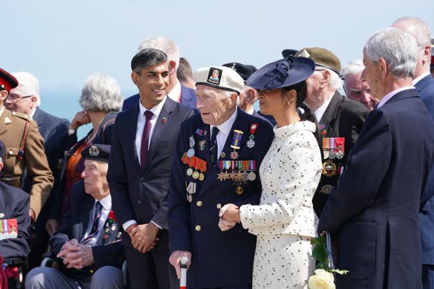 Rishi Sunak and wife Akshata Murty stand with D-Day veteran Alec Penstone, 98, following the UK national commemorative event for the 80th anniversary of D-Day, held at the British Normandy Memorial.