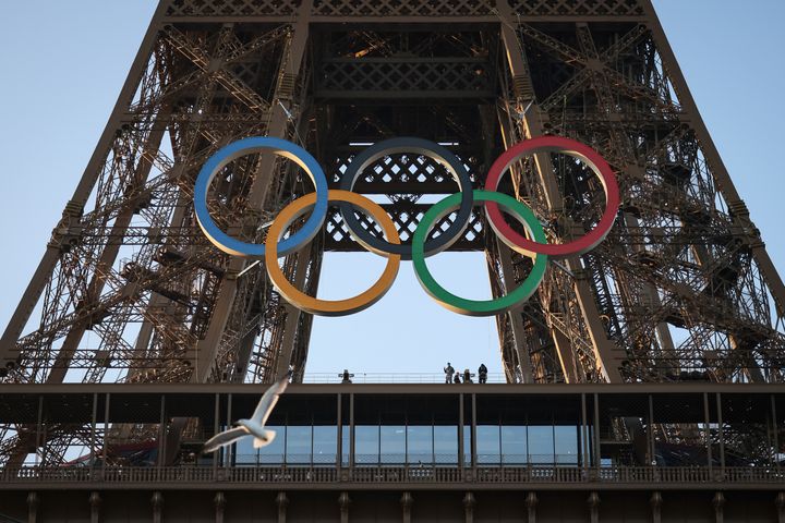 The Olympic rings are mounted on the Eiffel Tower Friday, June 7, 2024 in Paris. The Paris Olympics organizers mounted the rings on the Eiffel Tower on Friday as the French capital marks 50 days until the start of the Summer Games. The 95-foot-long and 43-foot-high structure of five rings, made entirely of recycled French steel, will be displayed on the south side of the 135-year-old historic landmark in central Paris, overlooking the Seine River. (AP Photo//Thomas Padilla)