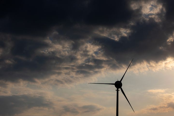 A wind turbine against a cloudy sky at sunset. Photographer: Krisztian Bocsi/Bloomberg