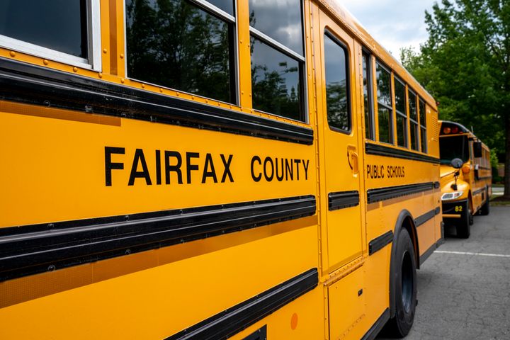 Fairfax County Public School buses sit idle at a middle school in Falls Church, Virginia, in July 2020. 